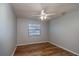 Spacious bedroom with wood-look floors and ceiling fan at 15123 Copeland Way, Spring Hill, FL 34604
