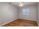 Bright bedroom with wood-look floors and ceiling fan at 15123 Copeland Way, Spring Hill, FL 34604