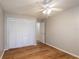 Bedroom with ceiling fan, wood-look floors and built-in closet at 15123 Copeland Way, Spring Hill, FL 34604