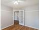 Bedroom with wood flooring and french doors to another room at 15123 Copeland Way, Spring Hill, FL 34604