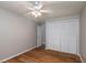 Bedroom with ceiling fan, wood-look floors and built-in closet at 15123 Copeland Way, Spring Hill, FL 34604