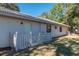 Rear exterior view showing a white, ranch-style home with a picket fence at 15123 Copeland Way, Spring Hill, FL 34604