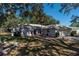 One-story house with a two-car garage and palm trees in the front yard at 15123 Copeland Way, Spring Hill, FL 34604