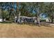 House exterior showcasing a large yard and shade trees at 15123 Copeland Way, Spring Hill, FL 34604