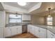 Modern kitchen featuring granite countertops, stainless steel appliances, and white cabinets at 15123 Copeland Way, Spring Hill, FL 34604