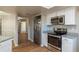 Kitchen with stainless steel appliances and light wood laminate flooring at 15123 Copeland Way, Spring Hill, FL 34604