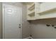 Laundry room with built-in shelving and exterior access at 15123 Copeland Way, Spring Hill, FL 34604