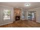 Living room with stone fireplace, sliding doors to patio, and pool view at 15123 Copeland Way, Spring Hill, FL 34604
