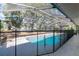 Inviting screened pool with safety fence and surrounding trees at 15123 Copeland Way, Spring Hill, FL 34604