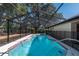 Relaxing screened pool with safety fence and large shade trees at 15123 Copeland Way, Spring Hill, FL 34604