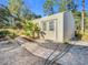 Well-maintained storage shed with a paved walkway at 13350 Cooper Rd, Spring Hill, FL 34609