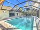 Refreshing swimming pool with screened enclosure and lush landscaping at 13350 Cooper Rd, Spring Hill, FL 34609