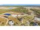 Aerial view of a spacious lot with pond and nearby homes at 24502 Yacht Club Blvd, Punta Gorda, FL 33955