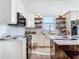 Modern kitchen with white cabinets, marble countertops, and a farmhouse sink at 24502 Yacht Club Blvd, Punta Gorda, FL 33955