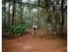 Person mountain biking on a wooded trail at 13271 Gulf Bay Ln, Spring Hill, FL 34609