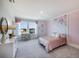 bedroom with floral wall decor and a plush pink bedspread at 7479 Rome Ln, Brooksville, FL 34613
