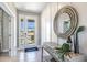 Elegant entryway with a large circular mirror and console table at 7479 Rome Ln, Brooksville, FL 34613