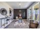Bright home office features a stylish desk, built-in shelving, and large windows at 7479 Rome Ln, Brooksville, FL 34613