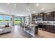Modern kitchen with dark brown cabinets, granite countertops, and an island at 7479 Rome Ln, Brooksville, FL 34613