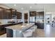 Modern kitchen with dark brown cabinets and granite island at 7479 Rome Ln, Brooksville, FL 34613