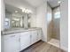 Modern bathroom with white cabinets, granite countertop and walk-in shower at 49 Marajo St, Punta Gorda, FL 33983