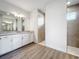 Bathroom with double vanity, walk-in shower, and granite countertops at 49 Marajo St, Punta Gorda, FL 33983