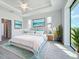 Spacious bedroom with large windows, wood-look floors, and ceiling fan at 49 Marajo St, Punta Gorda, FL 33983