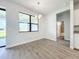 Bright dining room features wood-look floors and a view to the backyard at 49 Marajo St, Punta Gorda, FL 33983