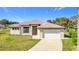 Single-story home with attached garage and landscaped lawn at 49 Marajo St, Punta Gorda, FL 33983