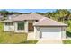 Single story home with a two-car garage and brown door at 49 Marajo St, Punta Gorda, FL 33983