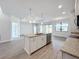 Kitchen island with granite countertops and stainless steel appliances at 49 Marajo St, Punta Gorda, FL 33983