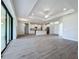 Open living room and kitchen area with high ceilings and wood-look floors at 49 Marajo St, Punta Gorda, FL 33983