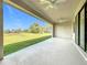 Covered patio with ceiling fans and serene backyard views at 49 Marajo St, Punta Gorda, FL 33983