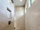 Walk-in shower with tile surround and multiple window at 49 Marajo St, Punta Gorda, FL 33983