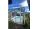 Enclosed pool with surrounding deck at 3390 Lambert Ave, Spring Hill, FL 34608