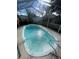 Enclosed kidney-shaped pool at 3390 Lambert Ave, Spring Hill, FL 34608