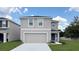 Charming two-story home with a two car garage and well-manicured lawn at 30942 Wild Juniper Ct, Brooksville, FL 34602