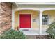 Inviting front porch with a bright red double door entrance at 8550 Berkley Dr, Hudson, FL 34667