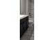 A bathroom featuring dark cabinets, granite countertop, tiled floor, and tub/shower combination at 13221 Gulf Bay Ln, Spring Hill, FL 34609