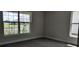 Bedroom featuring carpet, neutral walls, and windows that let in ample natural light at 13221 Gulf Bay Ln, Spring Hill, FL 34609