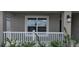 A cozy front porch area with white railings and lush green plants at 13221 Gulf Bay Ln, Spring Hill, FL 34609