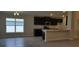Modern kitchen with dark cabinetry, granite countertops, and stainless steel appliances at 13221 Gulf Bay Ln, Spring Hill, FL 34609