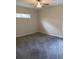 Neutral bedroom with carpeted floors, ceiling fan, and single window at 7724 Swiss Ave, North Port, FL 34291