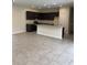 Spacious open-plan kitchen featuring dark cabinetry, stainless steel appliances, and granite countertops at 7724 Swiss Ave, North Port, FL 34291