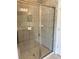 Modern tiled shower stall with glass door and chrome fixtures at 7724 Swiss Ave, North Port, FL 34291