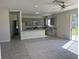 Open concept kitchen with stainless steel appliances, gray cabinets, and granite countertops at 1449 Marjorie Ln, North Port, FL 34286