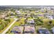 Aerial view of a quiet neighborhood featuring spacious lawns, mature trees, and neatly spaced homes at 2457 Tamworth Ter, Punta Gorda, FL 33983