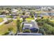 An elevated rear view reveals the pool deck beyond the thick foliage at 2457 Tamworth Ter, Punta Gorda, FL 33983