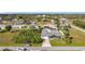 An elevated rear view reveals the pool deck beyond the lush foliage at 2457 Tamworth Ter, Punta Gorda, FL 33983