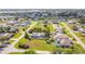 Aerial view of a neighborhood with manicured lawns and neatly fenced in homes near a waterway at 2457 Tamworth Ter, Punta Gorda, FL 33983